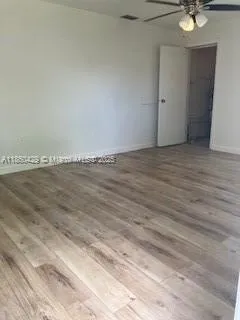a view of an empty room and wooden floor