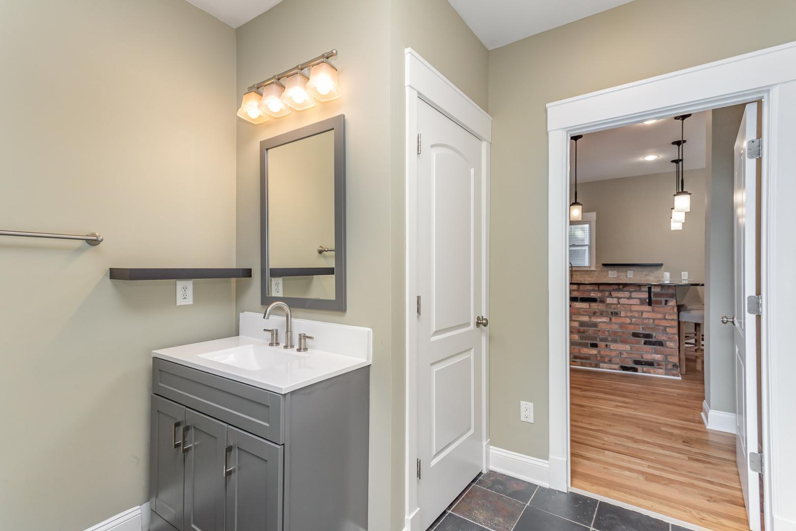 510 South Saunders Street Raleigh, NC 27603 - Photo 13 of 23 a bathroom with a sink a vanity and a mirror