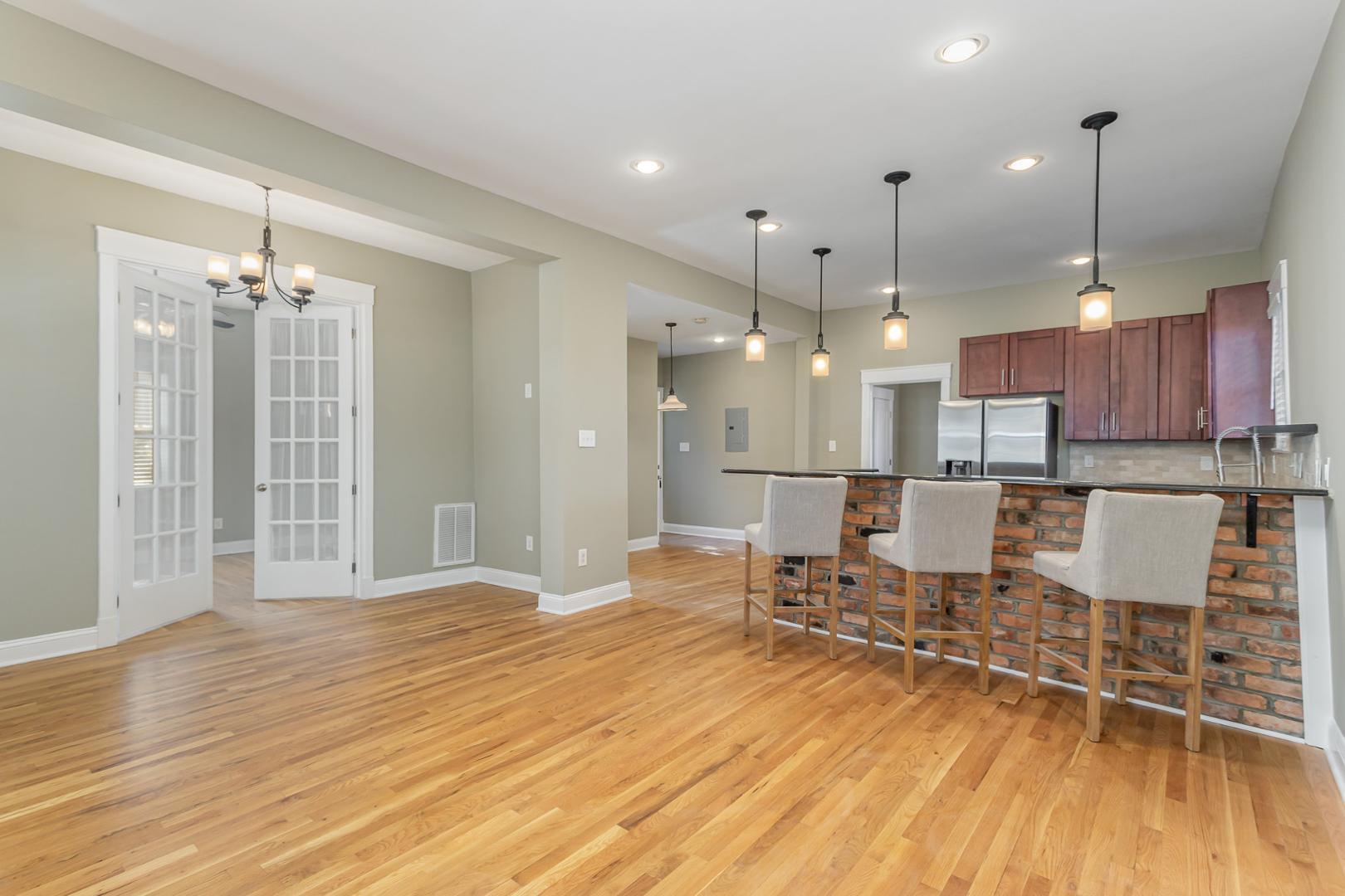 510 South Saunders Street Raleigh, NC 27603 - Photo 6 of 23 a open kitchen with stainless steel appliances granite countertop a refrigerator and a wooden floor