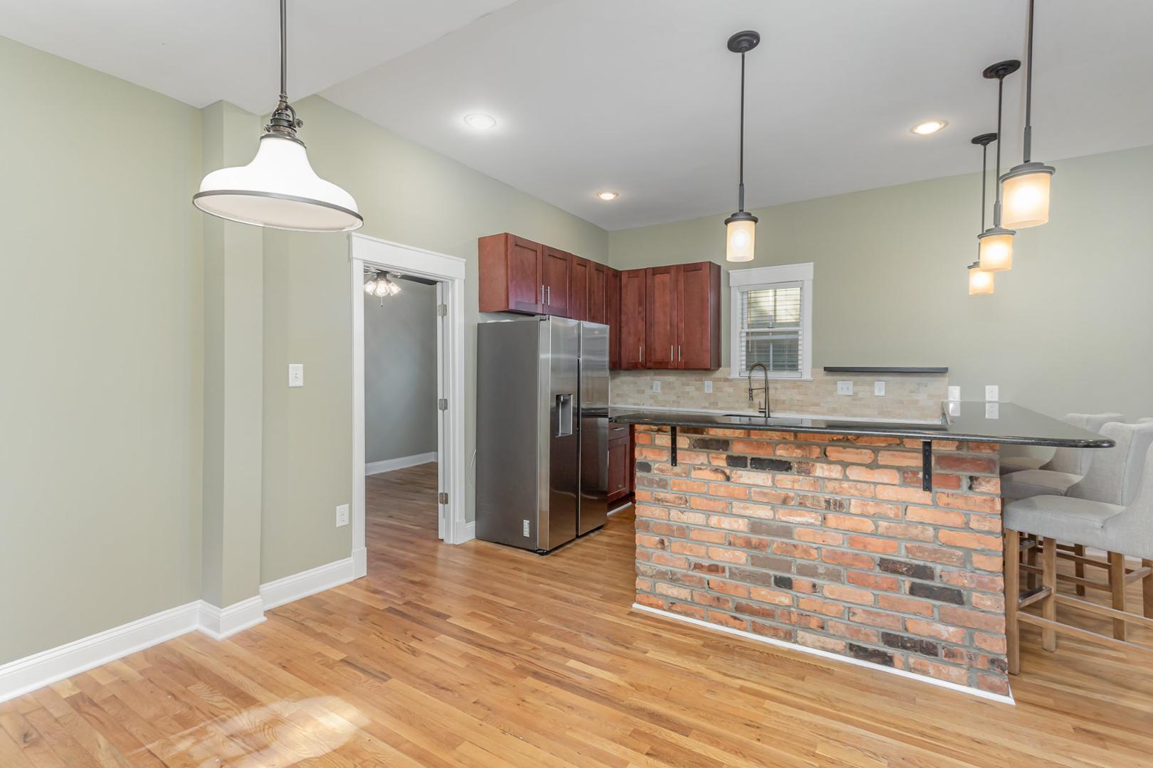 510 South Saunders Street Raleigh, NC 27603 - Photo 8 of 23 a kitchen with stainless steel appliances granite countertop cabinets a refrigerator and a wooden floor