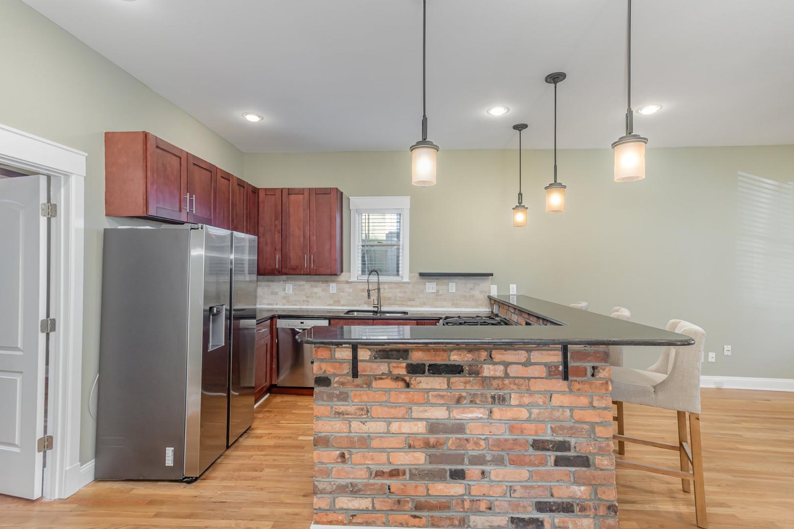 510 South Saunders Street Raleigh, NC 27603 - Photo 9 of 23 a kitchen with kitchen island a counter space a sink appliances and cabinets
