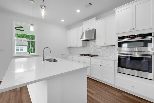 a kitchen with sink and microwave