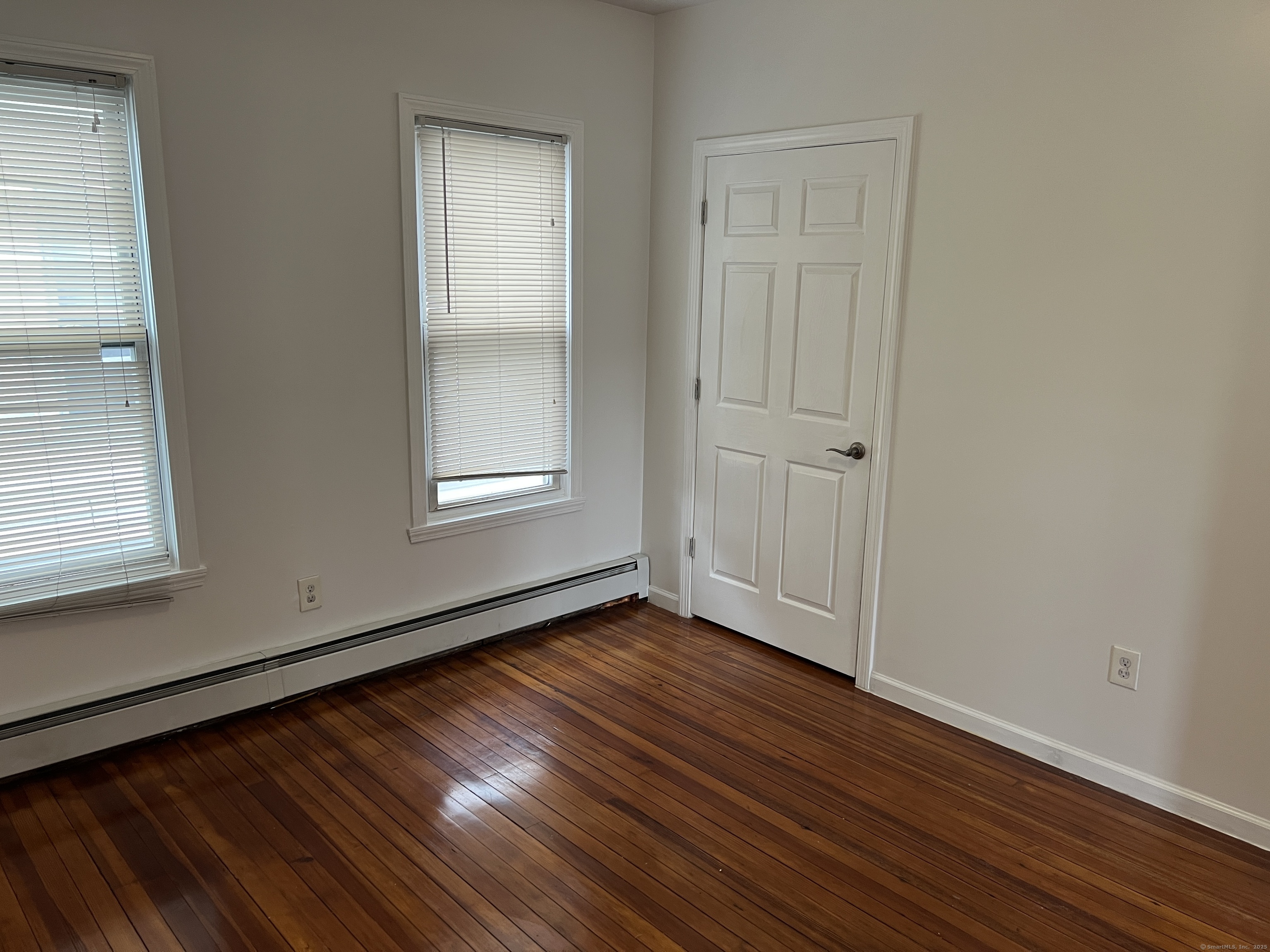 4 Magnolia Street, Unit 2 Hartford, CT 06112 - Photo 13 of 17 a view of an empty room with wooden floor and a window
