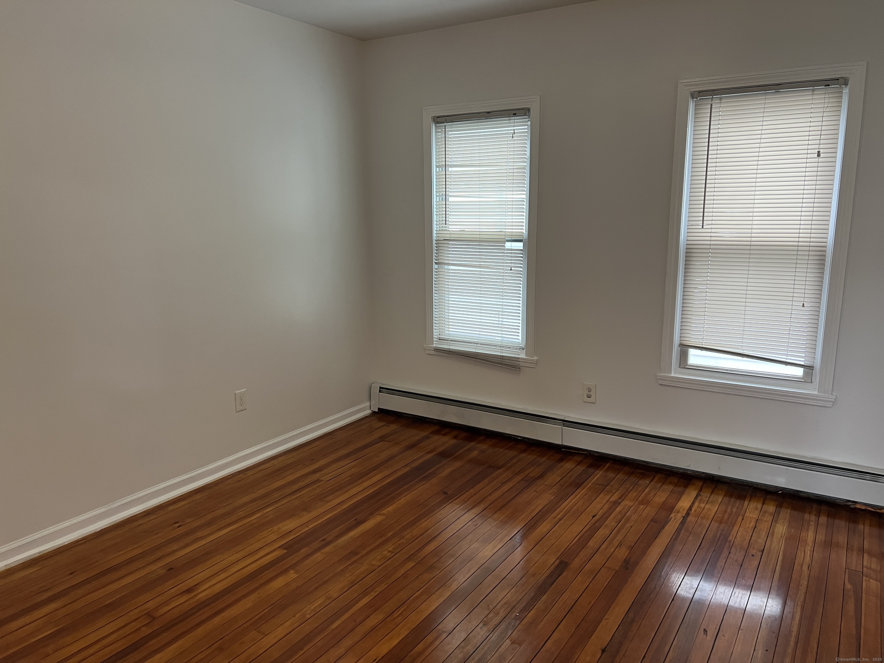 4 Magnolia Street, Unit 2 Hartford, CT 06112 - Photo 14 of 17 an empty room with wooden floor and windows