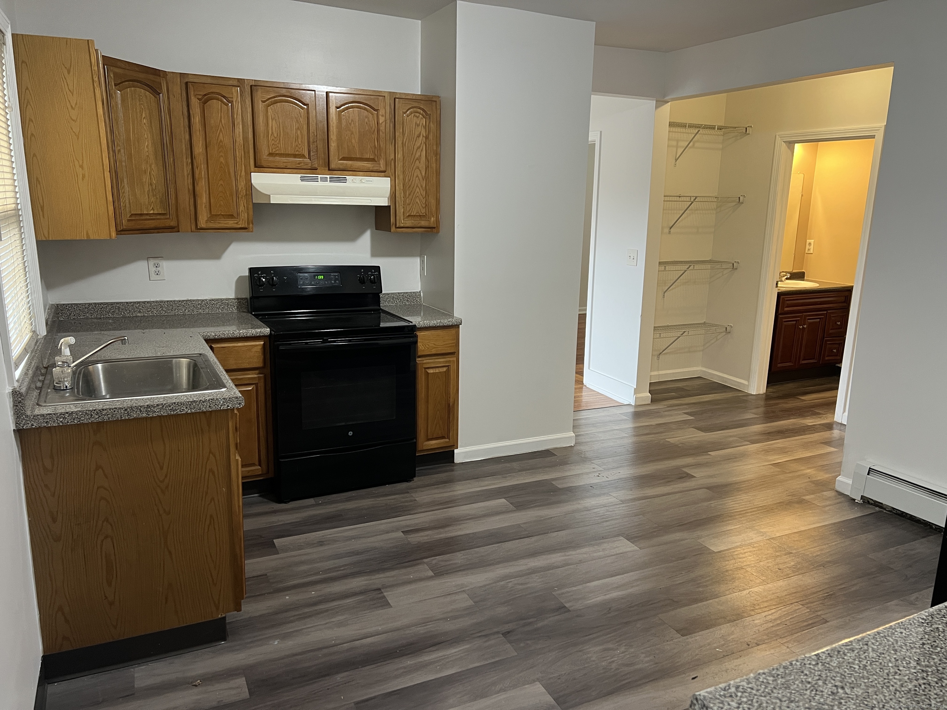 4 Magnolia Street, Unit 2 Hartford, CT 06112 - Photo 2 of 17 a kitchen with granite countertop wooden floors and stainless steel appliances