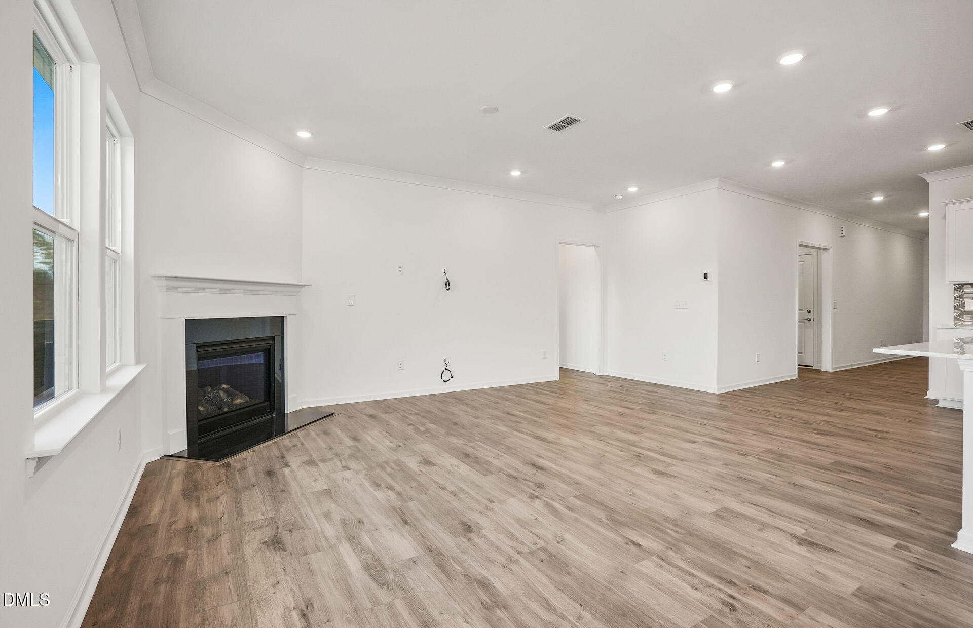 200 Armorial Court Willow Spring, NC 27592 - Photo 15 of 33 a view of empty room with wooden floor and fireplace