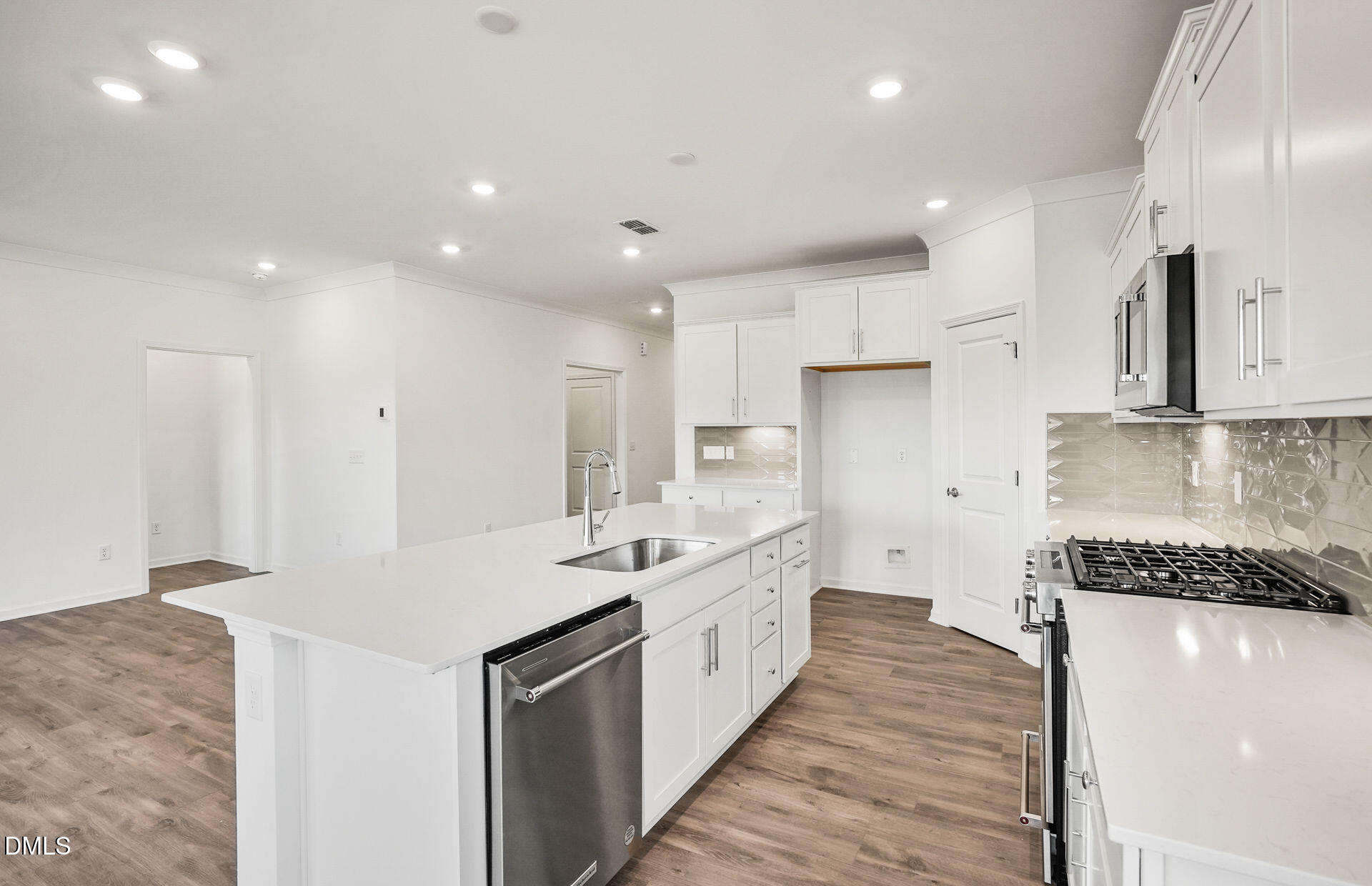 200 Armorial Court Willow Spring, NC 27592 - Photo 7 of 33 a large kitchen with stainless steel appliances lots of counter space and a sink