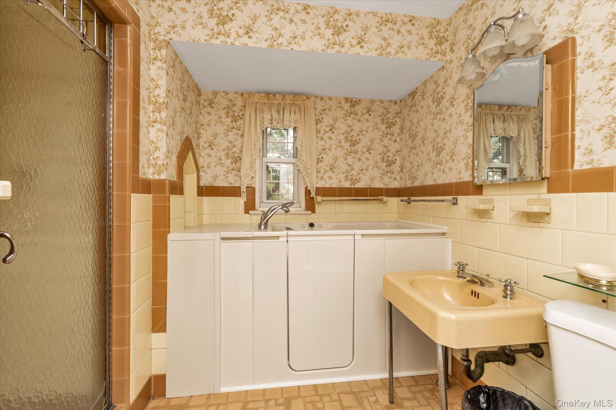 47-44 Glenwood Street Queens, NY 11362 - Photo 18 of 23 a bathroom with a sink and a mirror