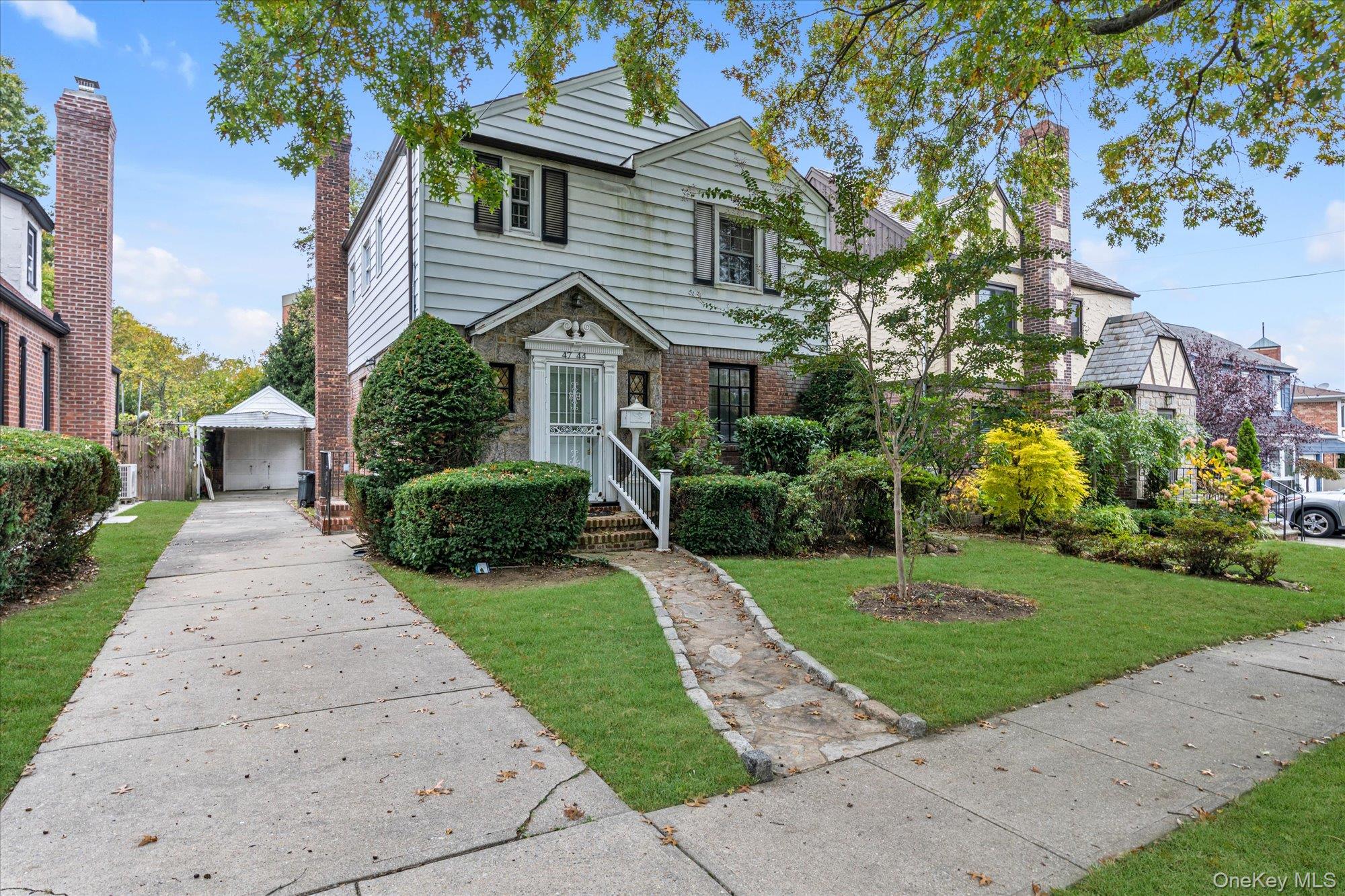 47-44 Glenwood Street Queens, NY 11362 - Photo 2 of 23 a front view of a house with a yard