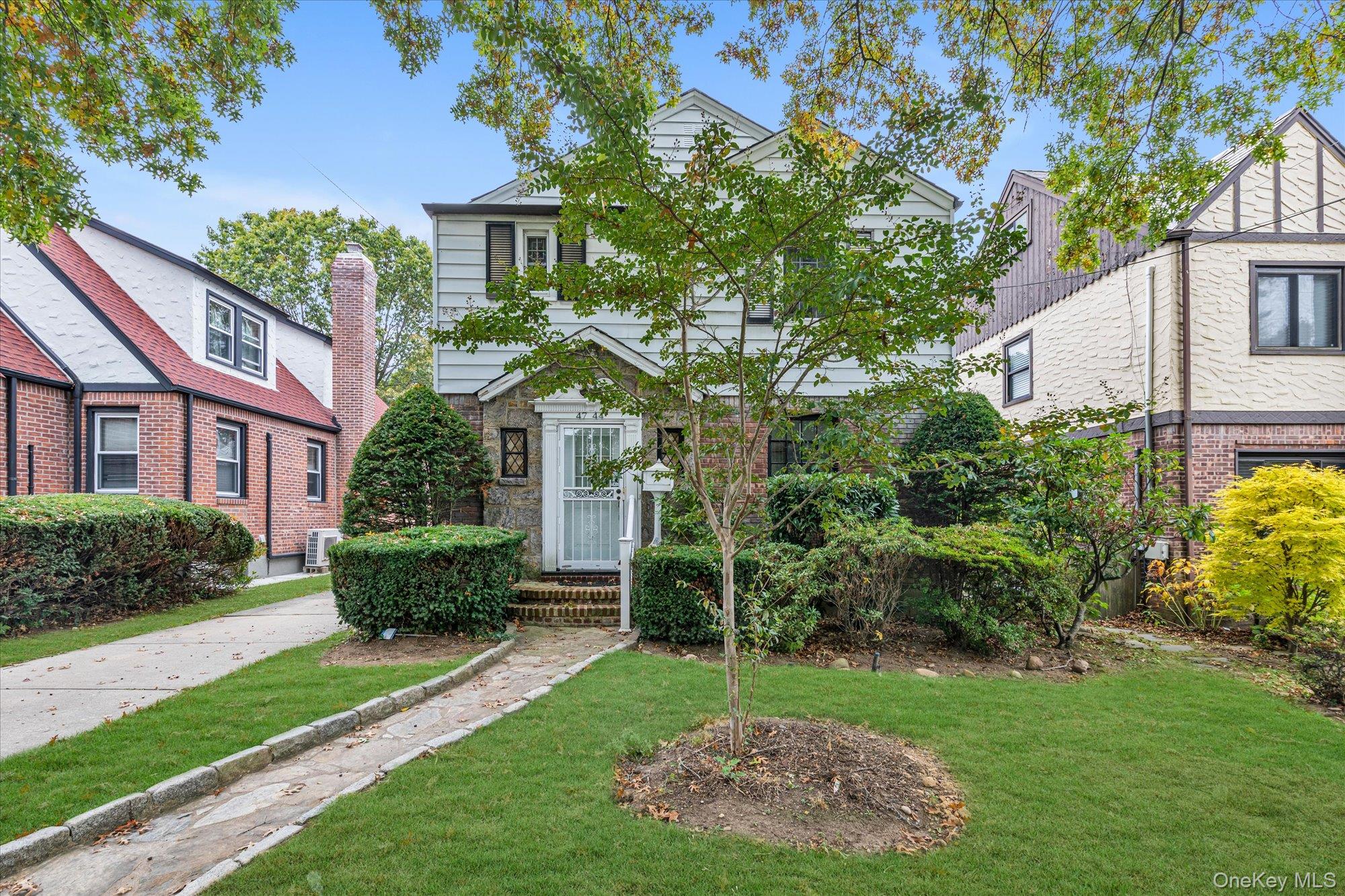 47-44 Glenwood Street Queens, NY 11362 - Photo 3 of 23 a view of a house with a garden