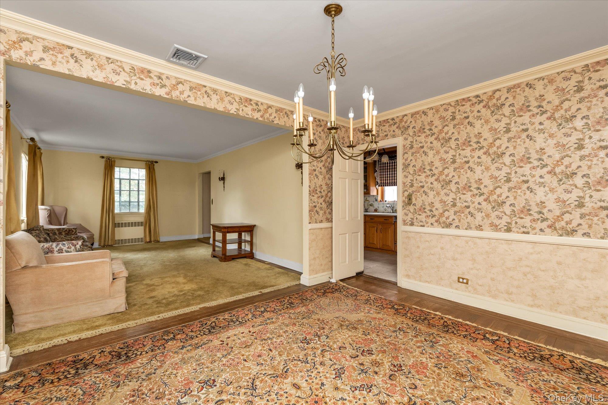 47-44 Glenwood Street Queens, NY 11362 - Photo 6 of 23 a view of a livingroom with a furniture wooden floor and a chandelier