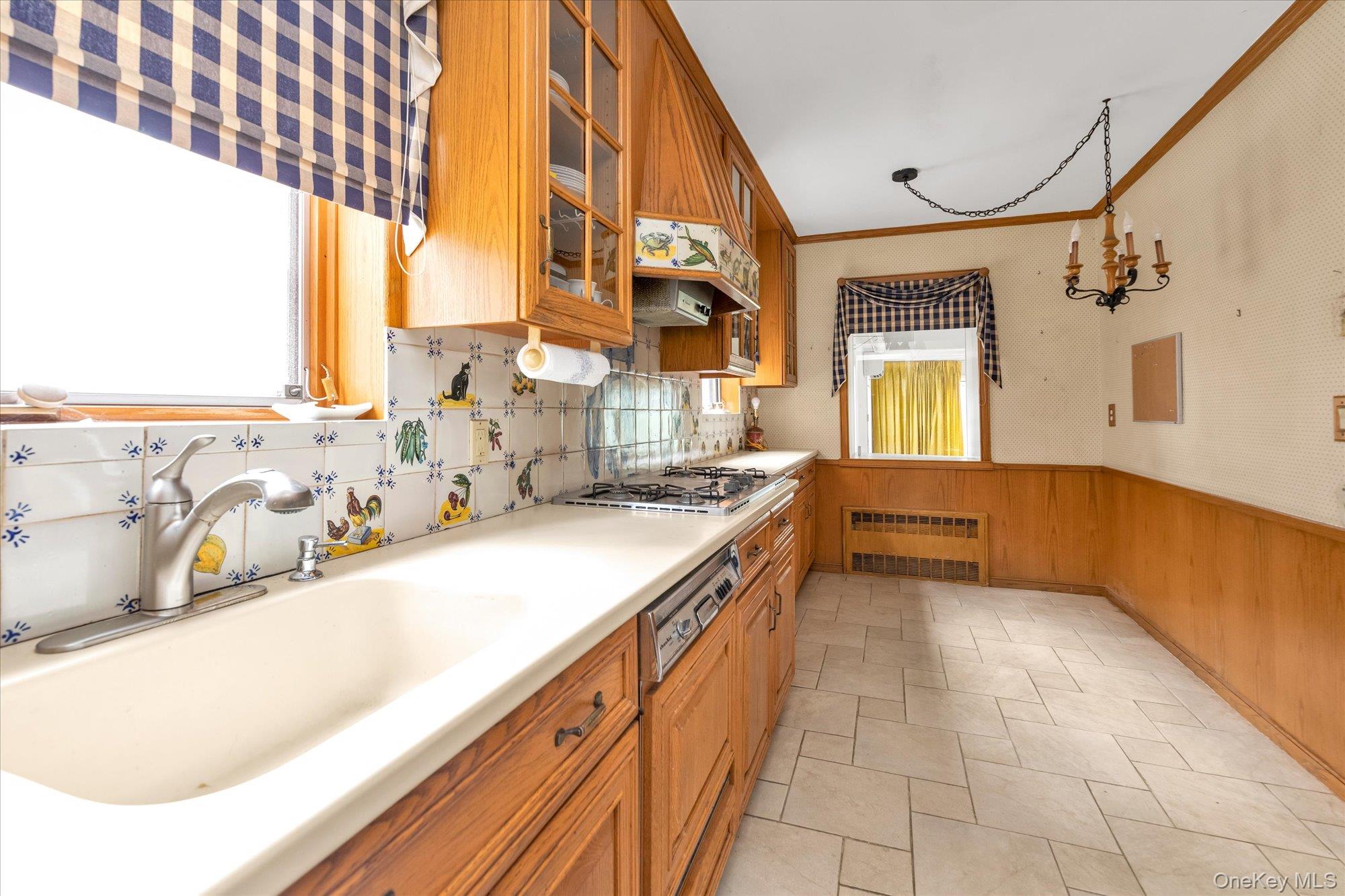 47-44 Glenwood Street Queens, NY 11362 - Photo 8 of 23 a kitchen with a sink and a stove
