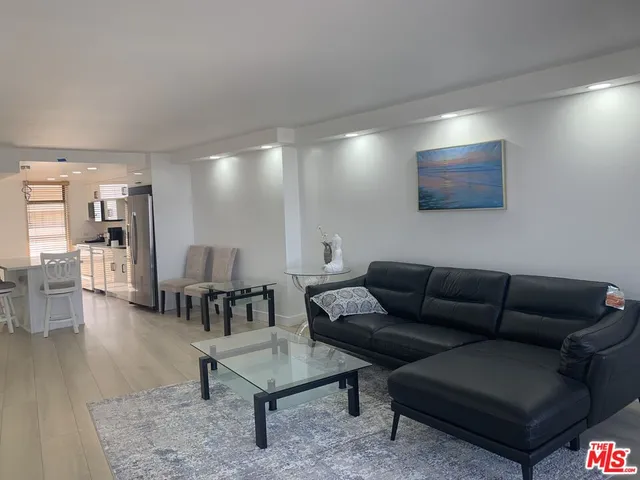 a living room with furniture a rug and a flat screen tv