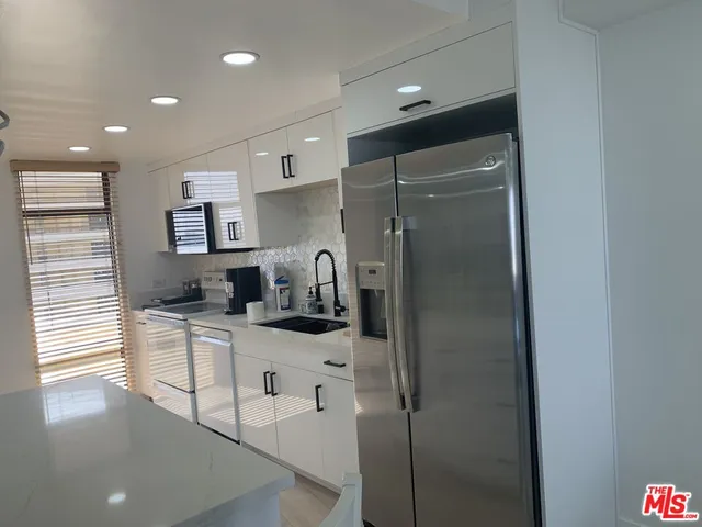 a kitchen with stainless steel appliances a refrigerator and a sink