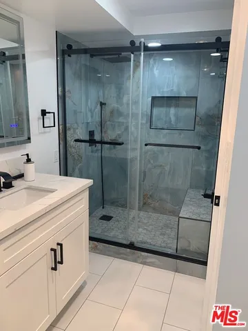 a bathroom with a shower and mirror