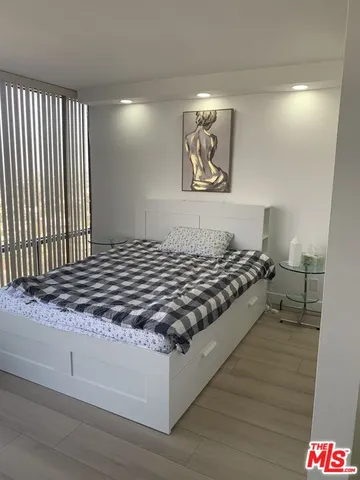 a living room with hard wood flooring and a couch