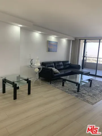 a living room with furniture and a lamp