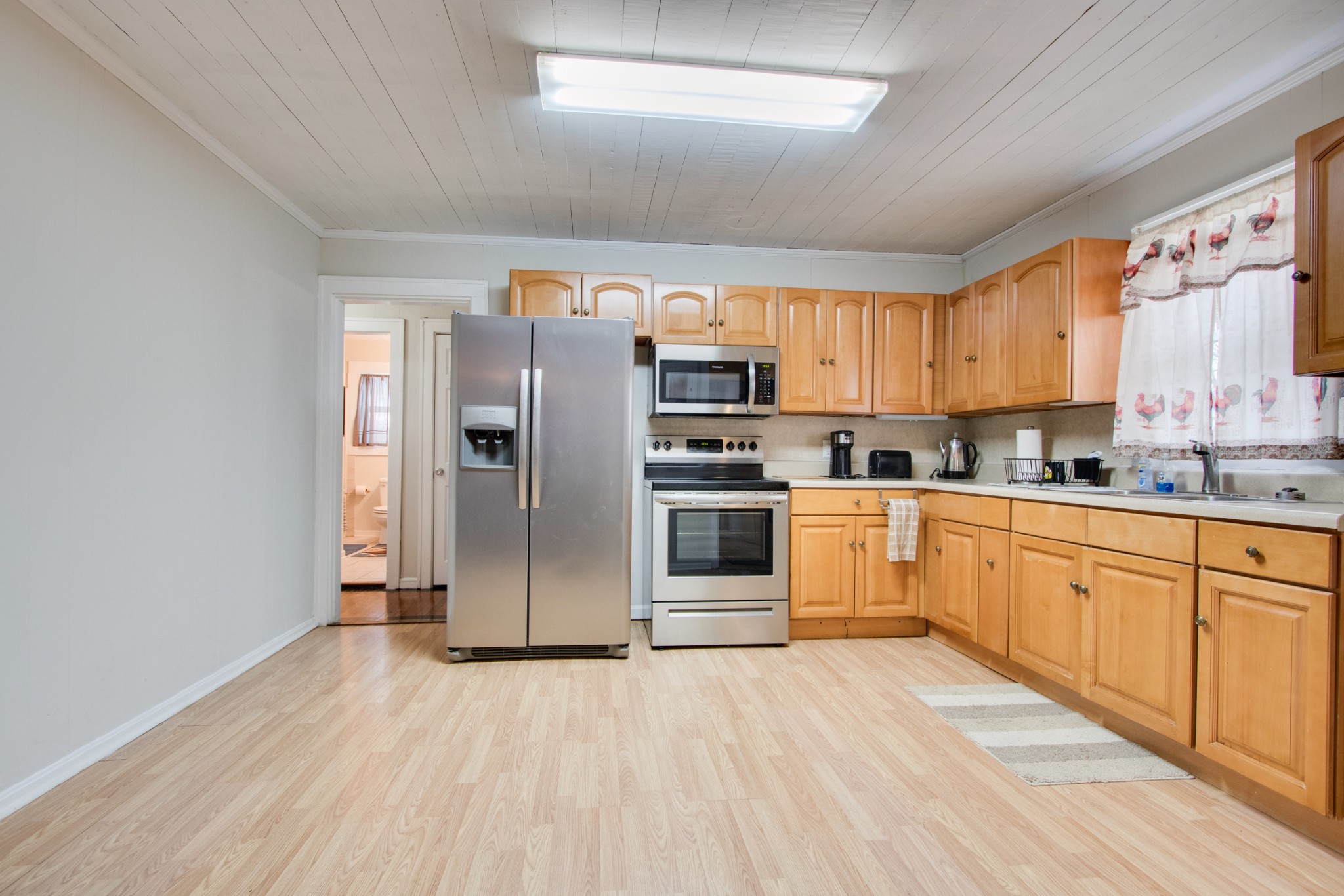 340 South Commerce Road Watertown, TN 37184 - Photo 16 of 38 a kitchen with stainless steel appliances a refrigerator and wooden cabinets