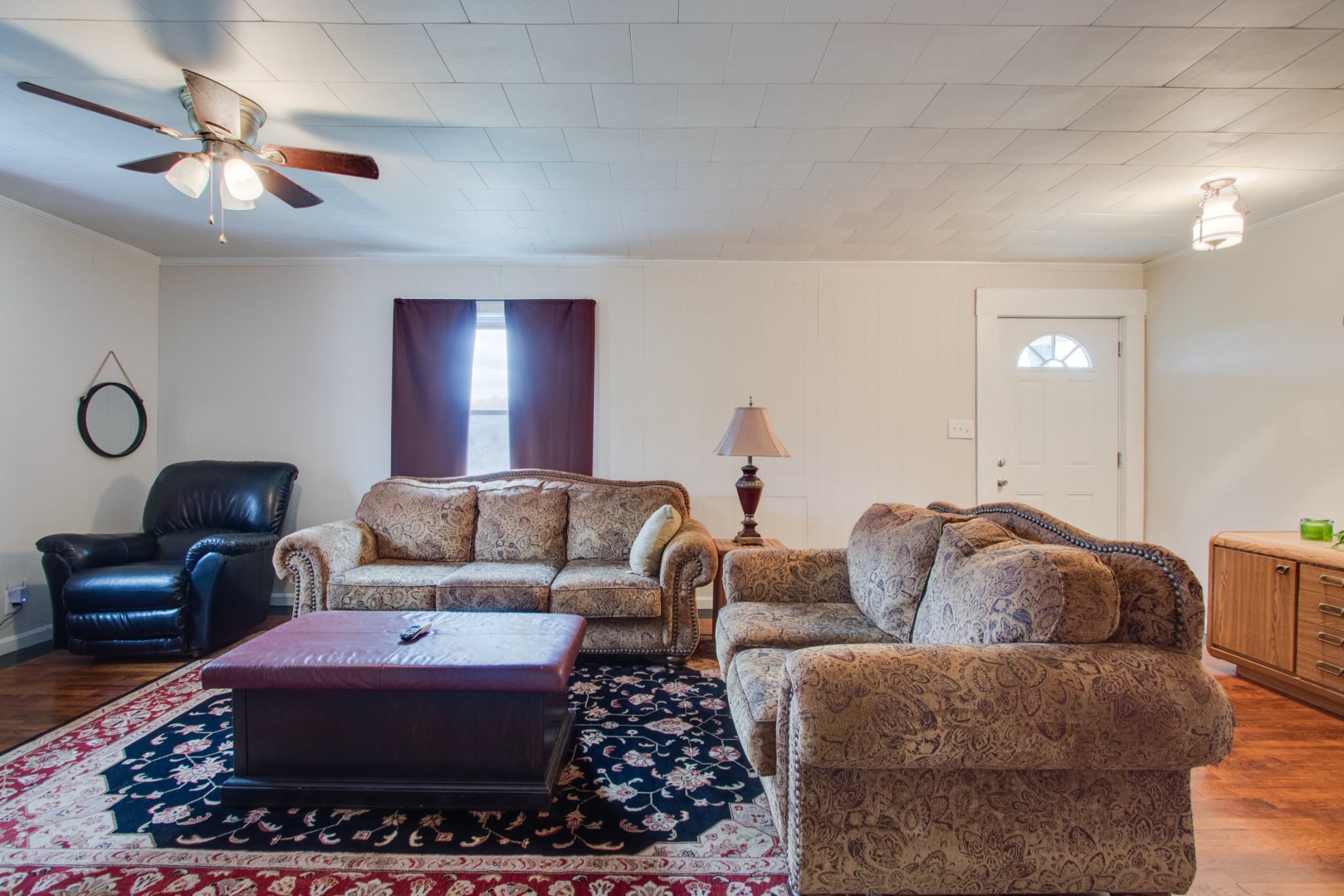 340 South Commerce Road Watertown, TN 37184 - Photo 7 of 38 a living room with furniture a chandelier and a rug