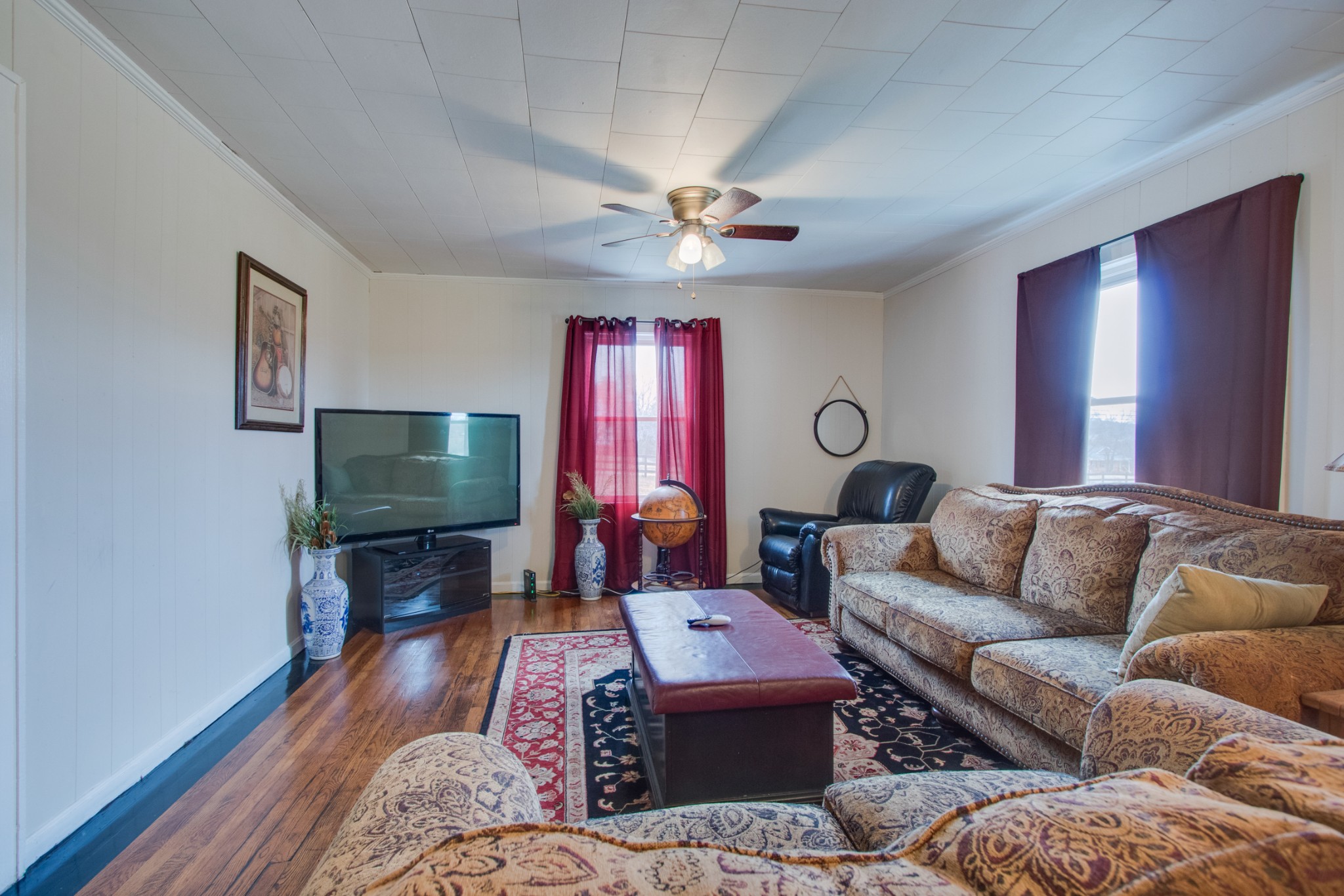 340 South Commerce Road Watertown, TN 37184 - Photo 9 of 38 a living room with furniture a flat screen tv and a window