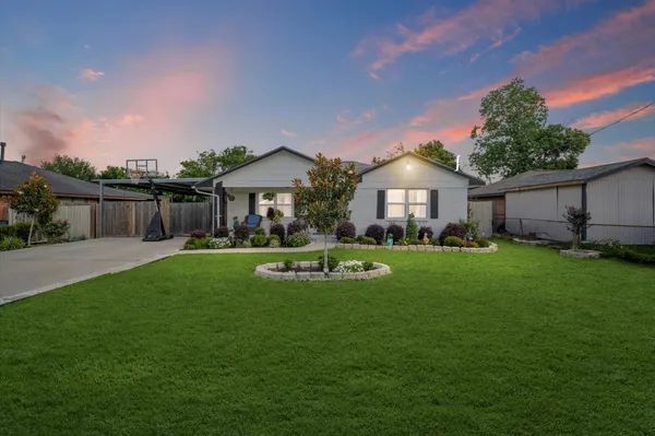 a front view of a house with a yard porch and outdoor seating