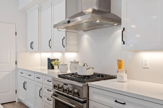 a stove top oven sitting inside of a kitchen