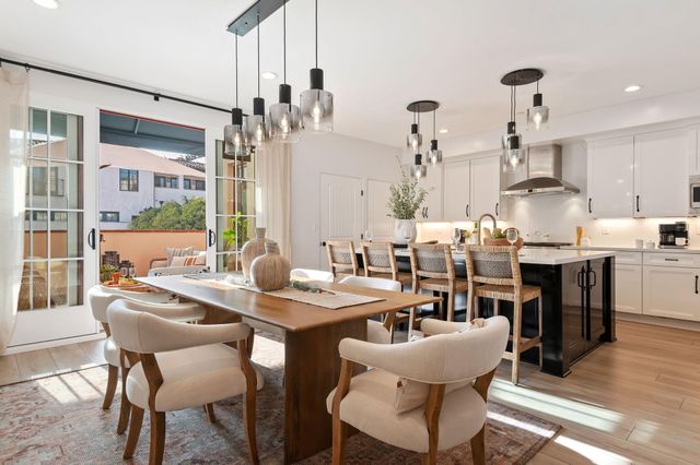 a view of a dining room with furniture and chandelier