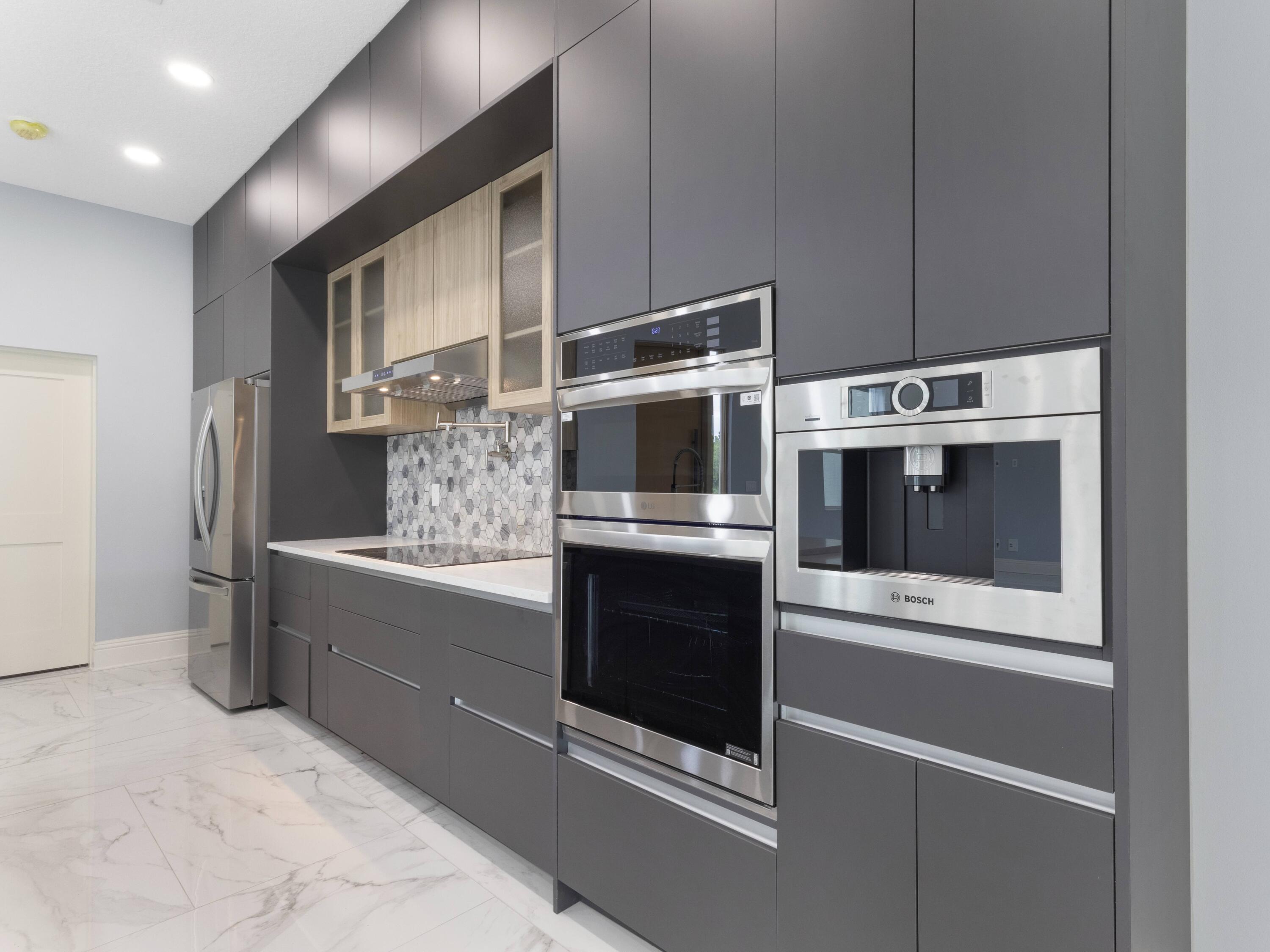 17436 71st Lane North Loxahatchee, FL 33470 - Photo 13 of 50 a kitchen with stainless steel appliances and granite countertop cabinets