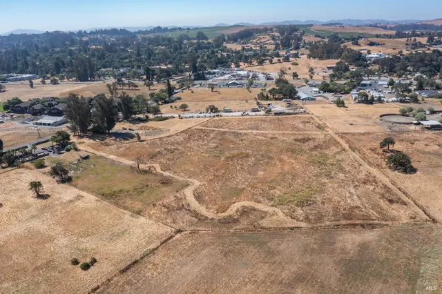 an aerial view of a house with a yard