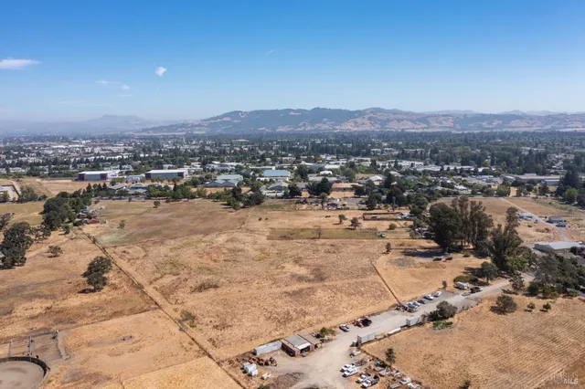 a view of a dry yard with trees
