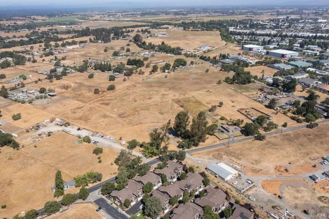 an aerial view of a house with a mountain
