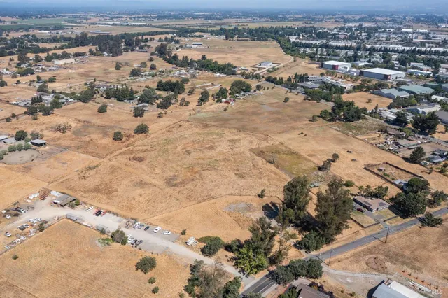 an aerial view of a house with a yard