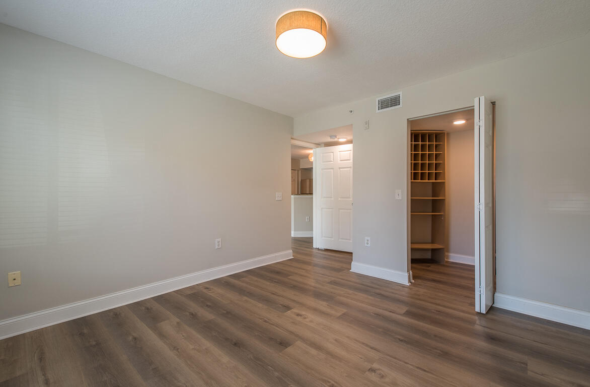 101 Villa Circle Boynton Beach, FL 33435 - Photo 11 of 49 an empty room with wooden floor and windows