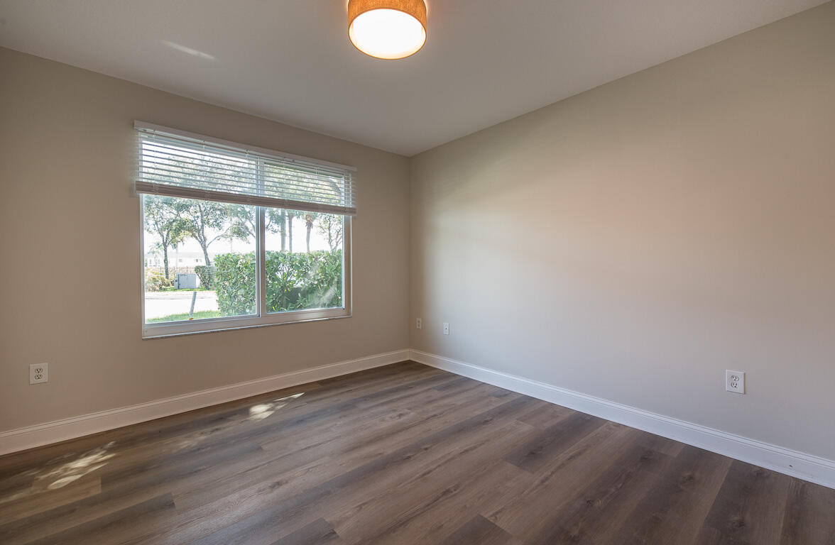 101 Villa Circle Boynton Beach, FL 33435 - Photo 20 of 49 an empty room with wooden floor and windows