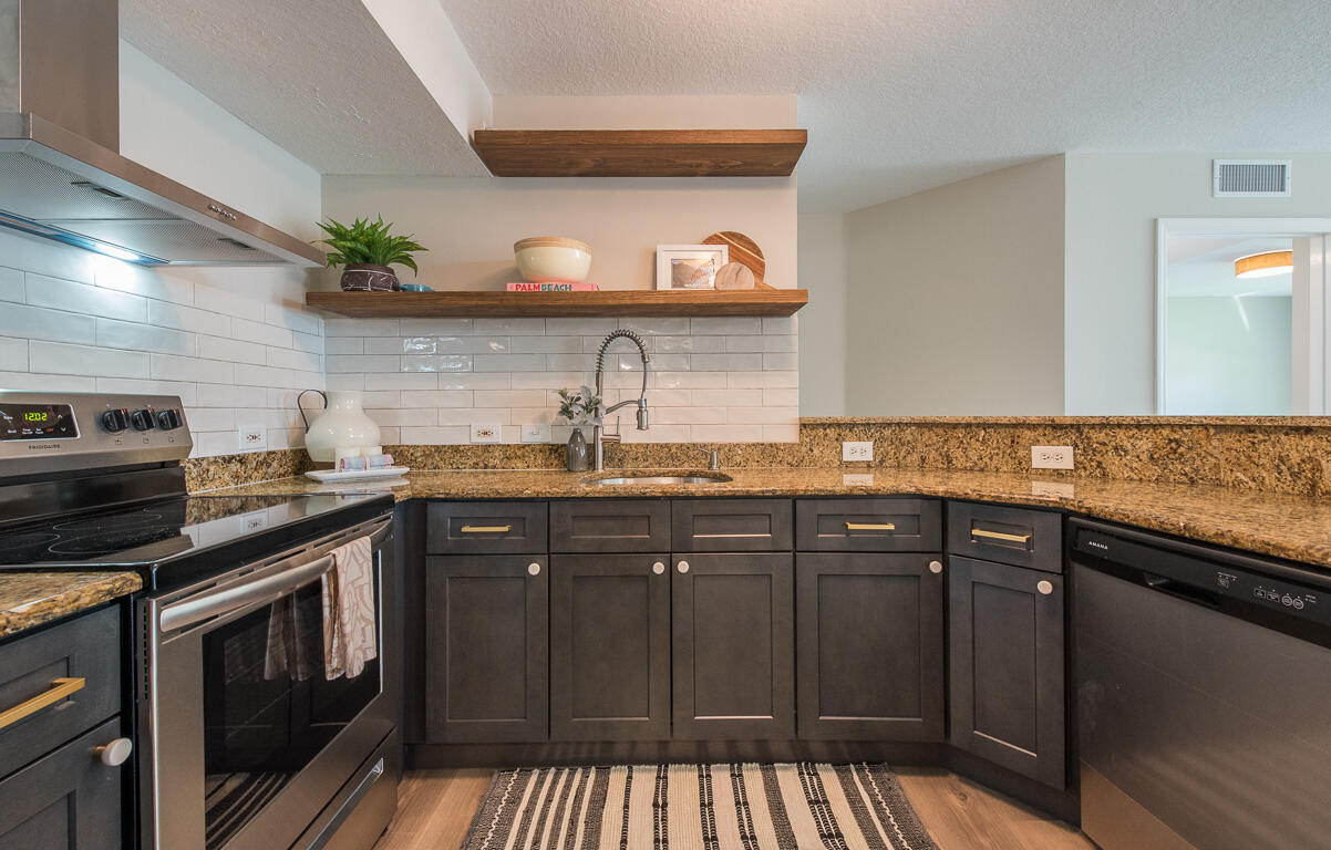 101 Villa Circle Boynton Beach, FL 33435 - Photo 2 of 49 a kitchen with granite countertop a sink and cabinets