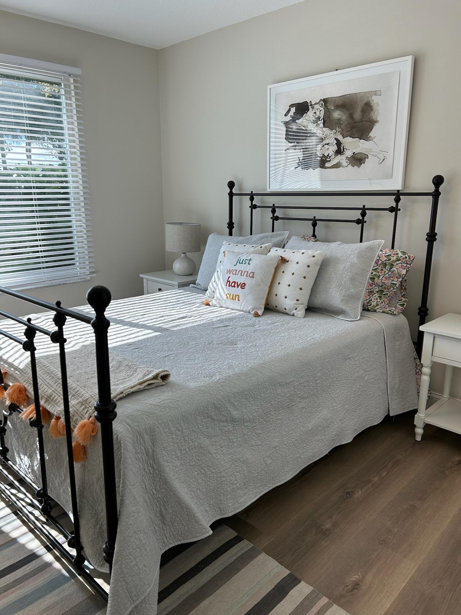 101 Villa Circle Boynton Beach, FL 33435 - Photo 42 of 49 a large bed sitting in a bedroom next to a window