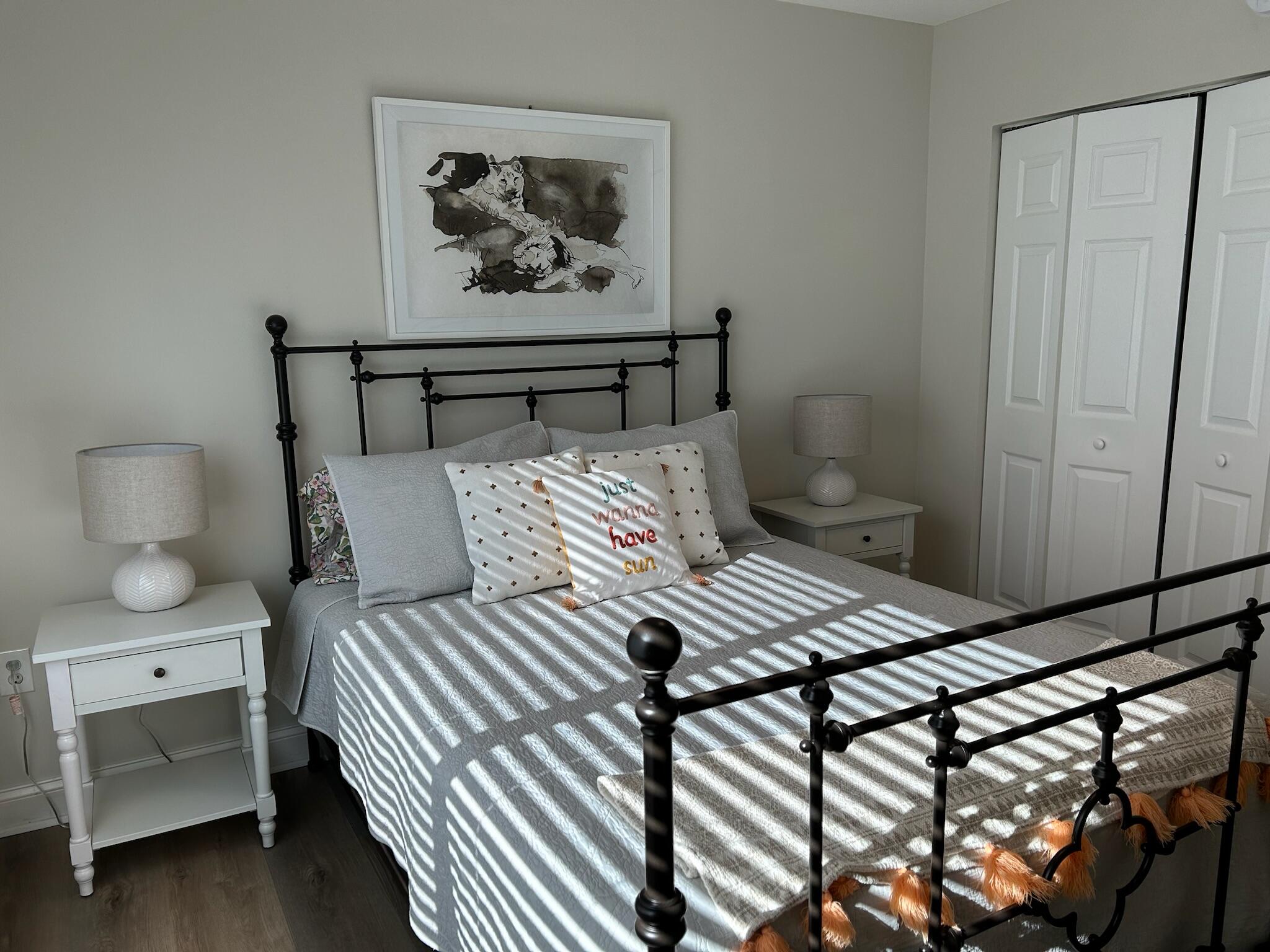 101 Villa Circle Boynton Beach, FL 33435 - Photo 44 of 49 a bedroom with a bed and a painting on the wall