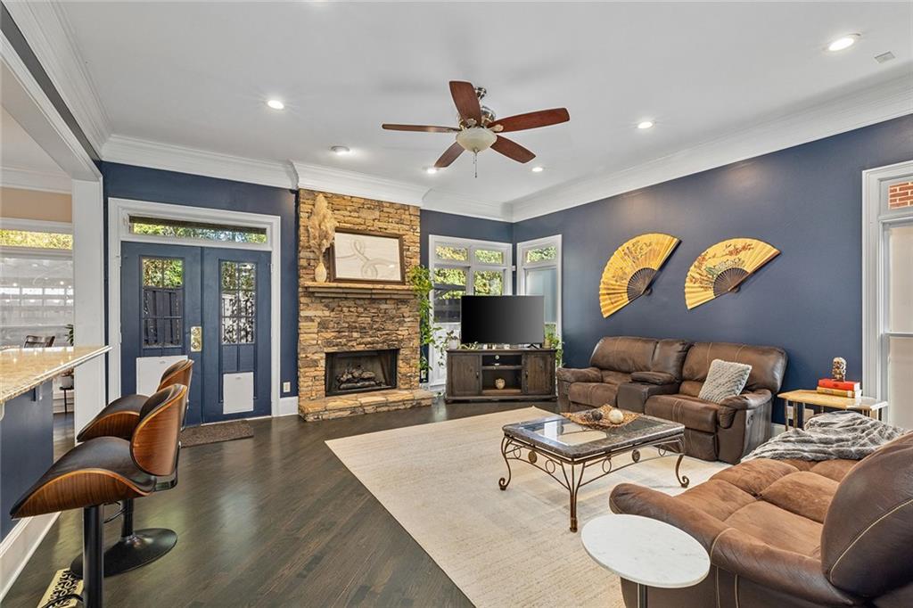 2694 Lenox Road Northeast Atlanta, GA 30324 - Photo 12 of 28 a living room with furniture a fireplace and a flat screen tv