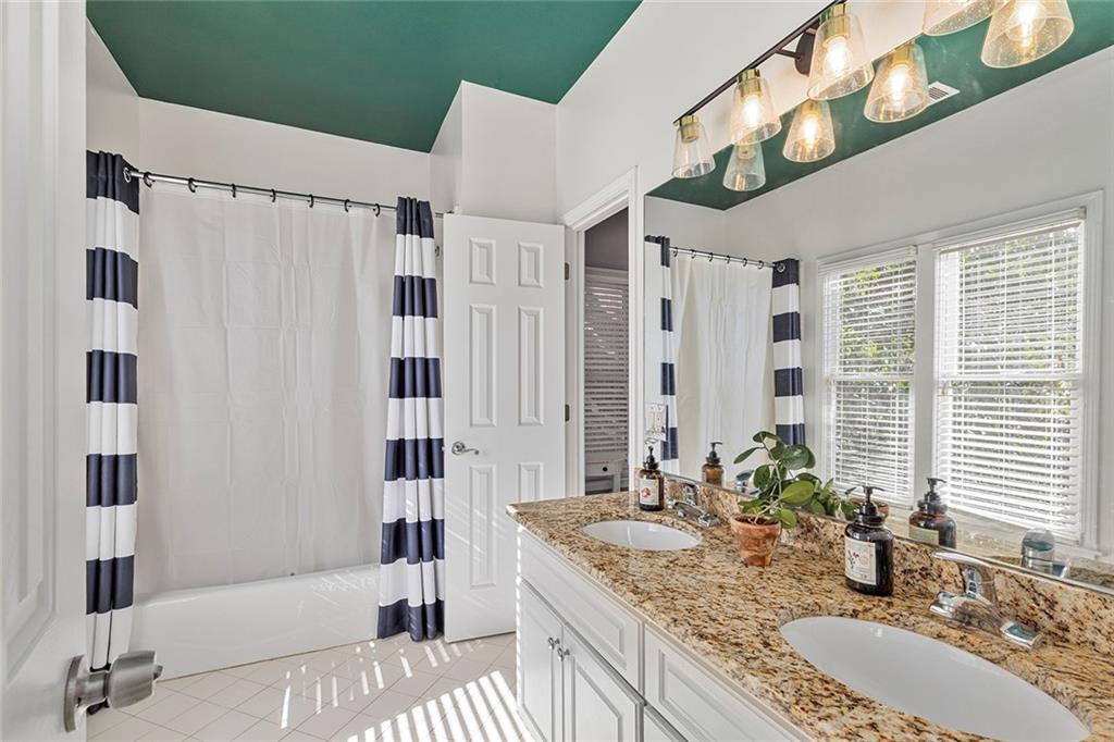 2694 Lenox Road Northeast Atlanta, GA 30324 - Photo 14 of 28 a bathroom with a granite countertop double vanity sink and a mirror