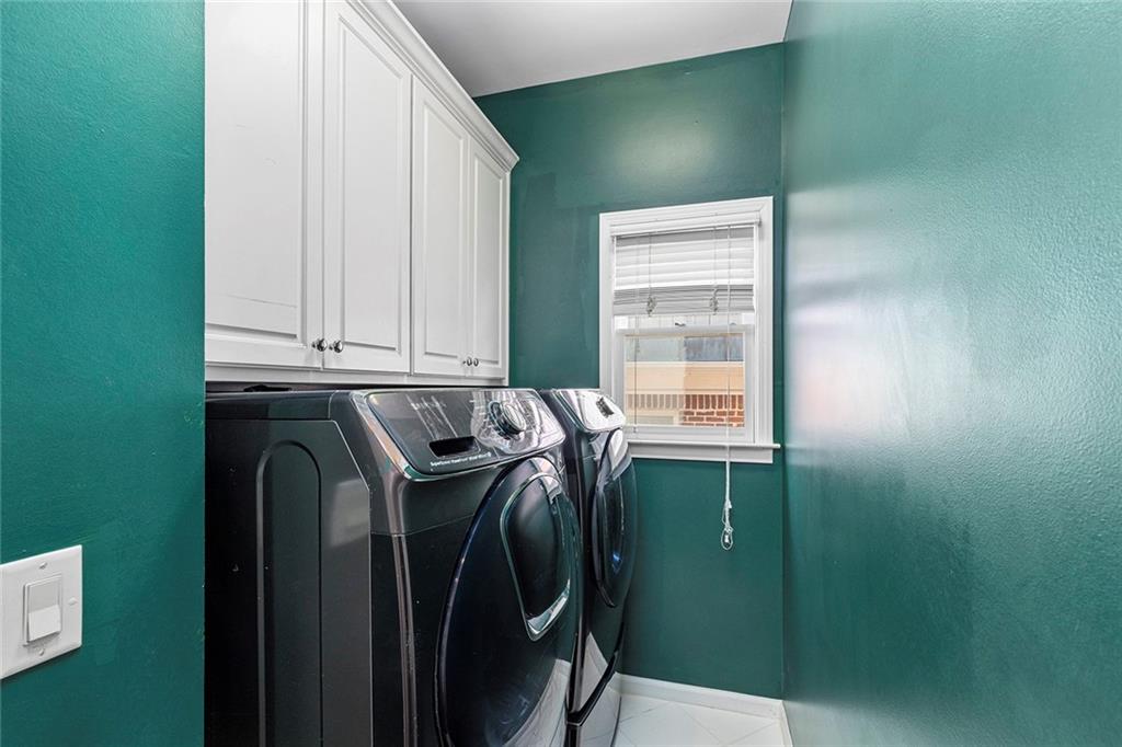 2694 Lenox Road Northeast Atlanta, GA 30324 - Photo 16 of 28 a bathroom with a sink a mirror and a shower