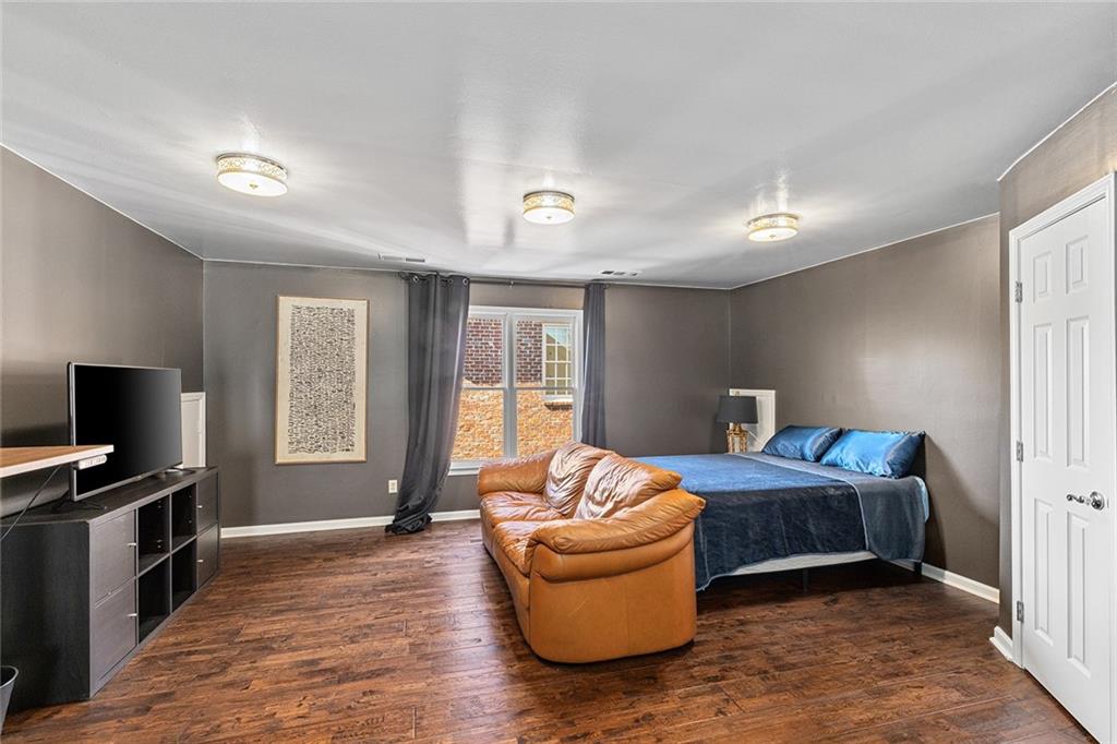 2694 Lenox Road Northeast Atlanta, GA 30324 - Photo 22 of 28 a bedroom with furniture and a flat screen tv
