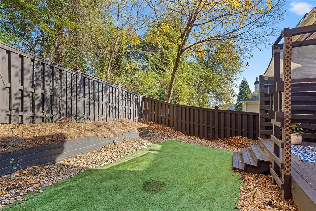 2694 Lenox Road Northeast Atlanta, GA 30324 - Photo 28 of 28 a view of a backyard with wooden fence and a bench