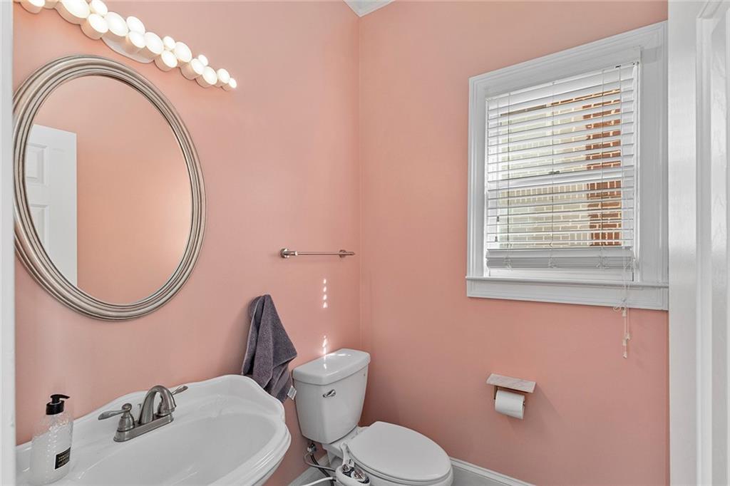 2694 Lenox Road Northeast Atlanta, GA 30324 - Photo 4 of 28 a bathroom with a toilet a sink and a mirror