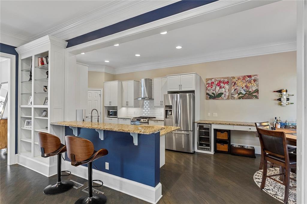 2694 Lenox Road Northeast Atlanta, GA 30324 - Photo 6 of 28 a view of kitchen with stainless steel appliances granite countertop a dining table chairs and a refrigerator