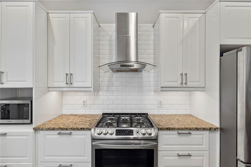 2694 Lenox Road Northeast Atlanta, GA 30324 - Photo 7 of 28 a stove top oven sitting inside of a kitchen