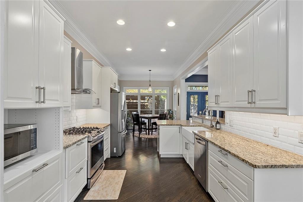 2694 Lenox Road Northeast Atlanta, GA 30324 - Photo 8 of 28 a kitchen with white cabinets and appliances