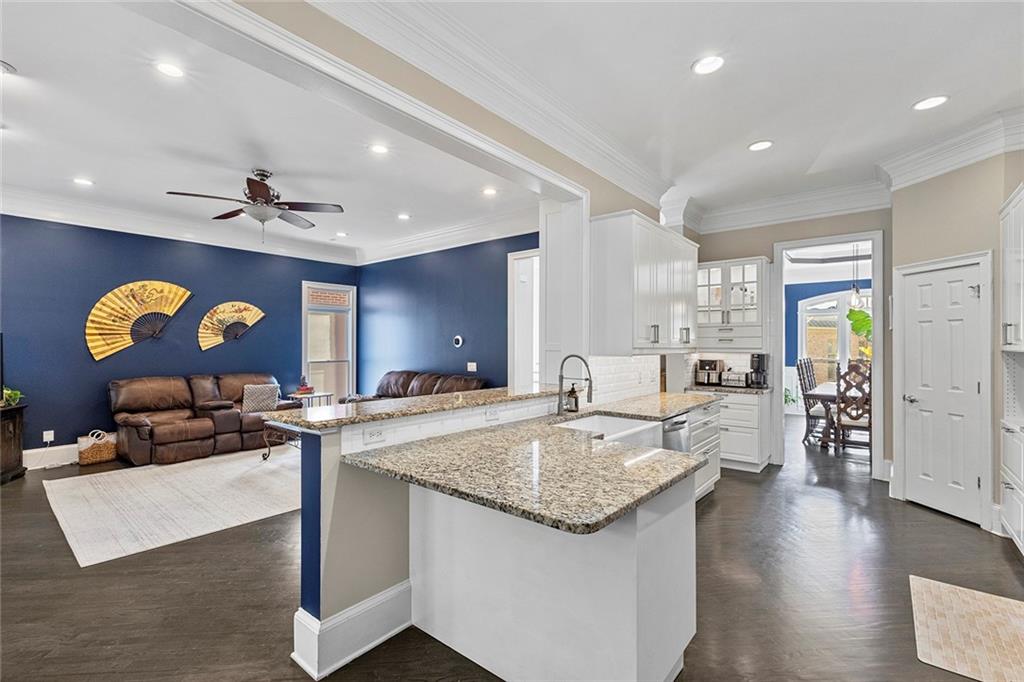 2694 Lenox Road Northeast Atlanta, GA 30324 - Photo 10 of 28 a large kitchen with stainless steel appliances granite countertop a sink a stove counter space and cabinets