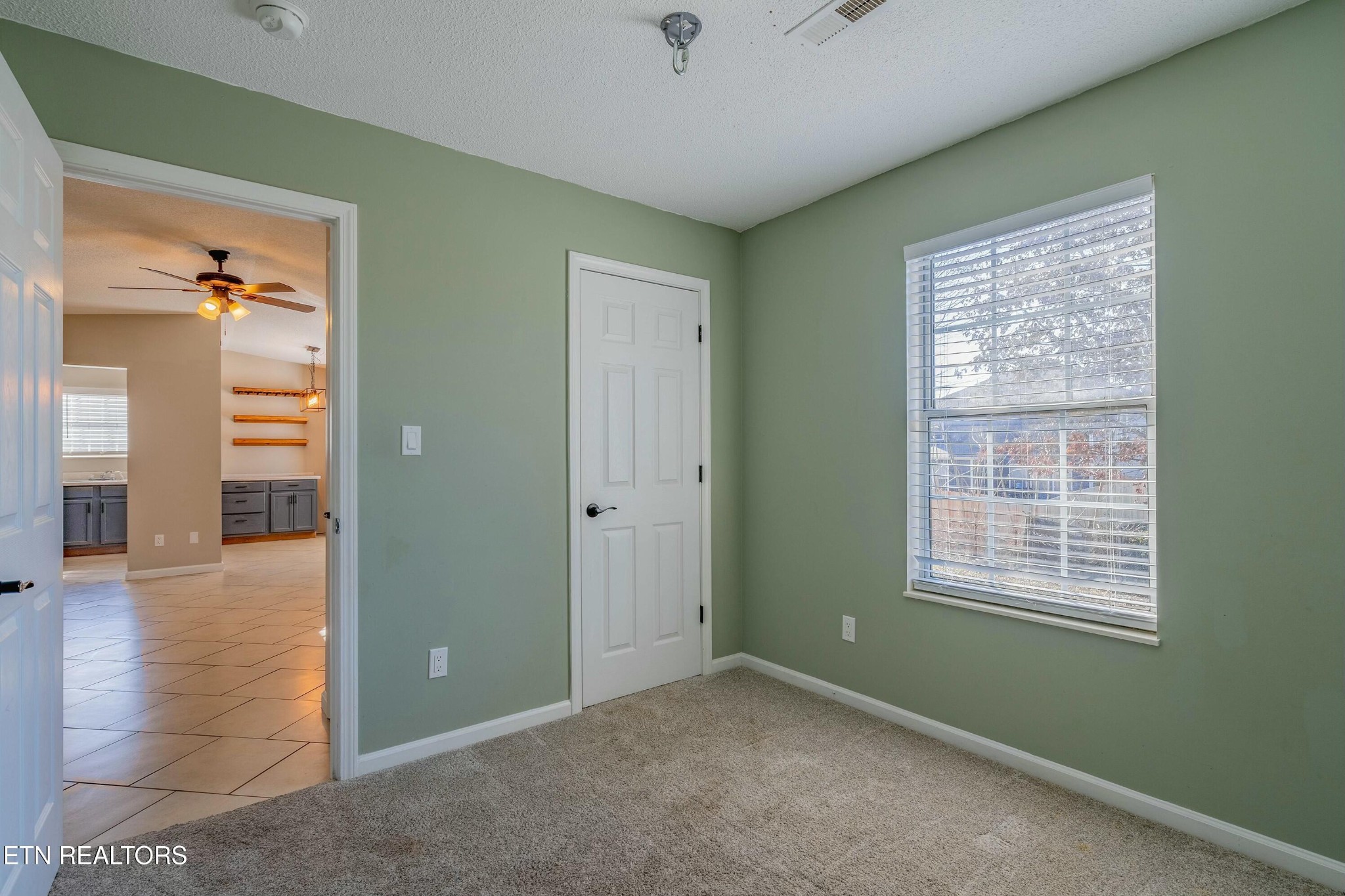 7724 Ralph Youmans Road Corryton, TN 37721 - Photo 14 of 19 a view of an empty room with window and stairs