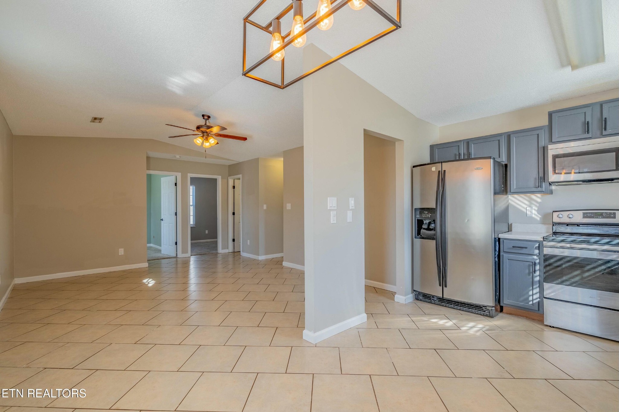 7724 Ralph Youmans Road Corryton, TN 37721 - Photo 5 of 19 a view of a refrigerator in kitchen and an empty room