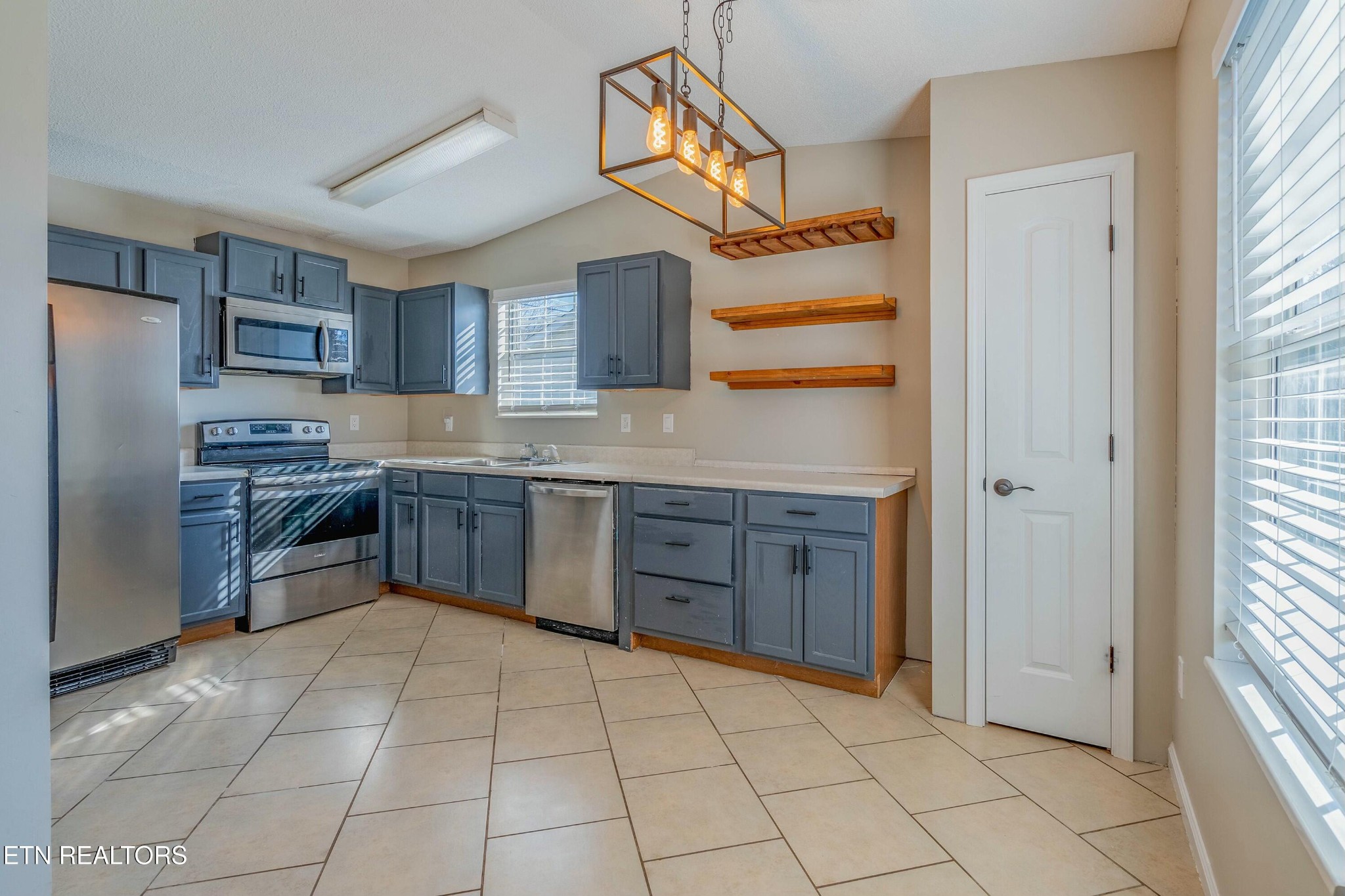 7724 Ralph Youmans Road Corryton, TN 37721 - Photo 6 of 19 a kitchen with stainless steel appliances granite countertop a stove sink and refrigerator